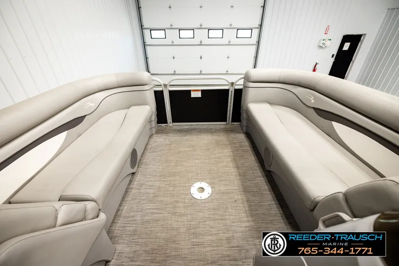 Slide: The Image of Interior of a 2021 Bennington SVSR boat with beige seating and carpet flooring. - 20