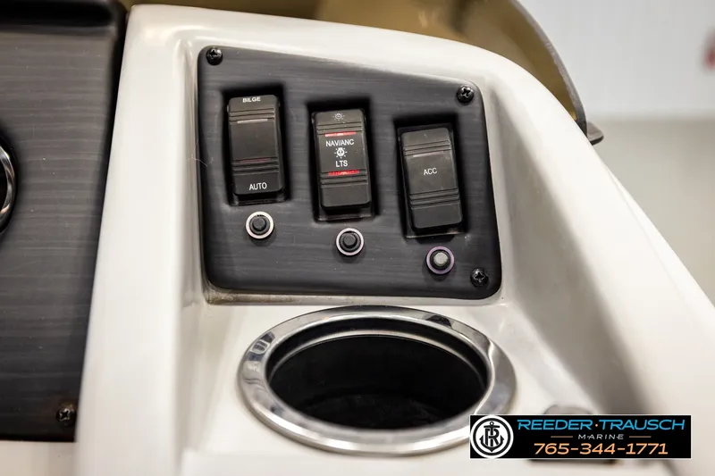 Slide: The Image of Control panel of a 2021 Bennington SVSR boat with switches and cup holder. - 38