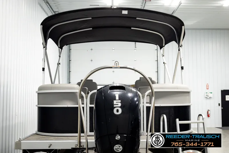 Slide: The Image of 2021 Bennington SVSR pontoon boat with 150 horsepower engine in a showroom. - 7