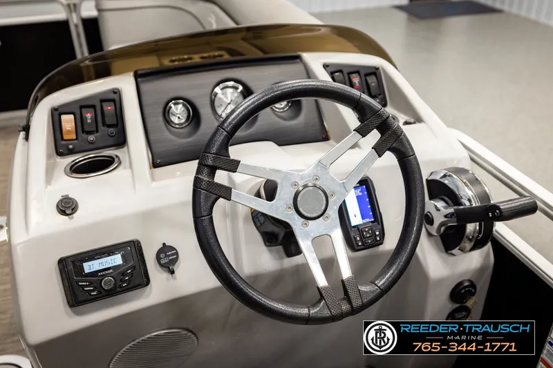 Slide: The Image of 2021 Bennington SVSR boat dashboard with steering wheel and control panel. - 31