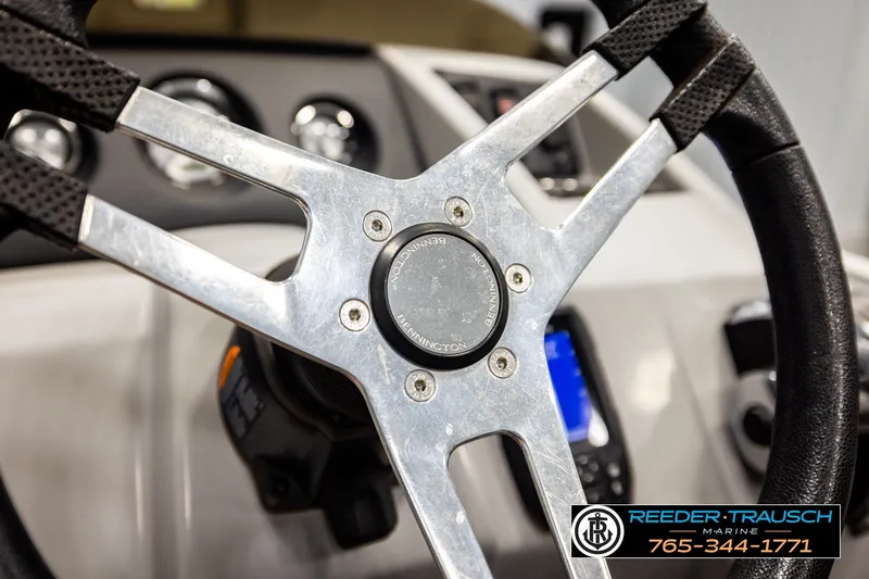 Slide: The Image of Steering wheel of a 2021 Bennington SVSR boat, featuring a sleek metallic design. - 32