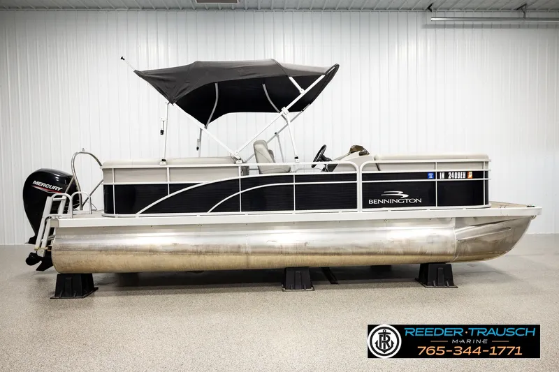 Slide: The Image of 2021 Bennington SVSR pontoon boat with canopy, displayed indoors at Reeder Trausch Marine. - 5