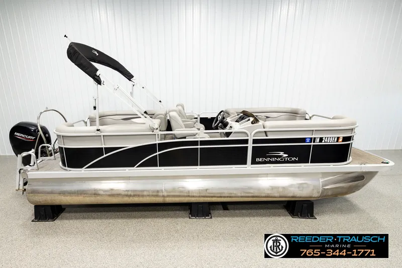 The Image of 2021 Bennington SVSR pontoon boat with Mercury engine, displayed indoors at Reeder-Trausch Marine. - 1