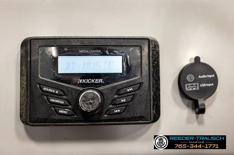 Slide: The Image of ```json { "alt_text": "2021 Bennington SVSR Kicker media center with audio and USB input options." } ``` - 33