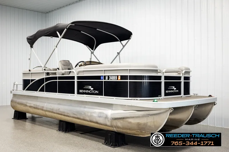 Slide: The Image of 2021 Bennington SVSR pontoon boat with canopy, displayed indoors at Reeder Trausch Marine. - 3