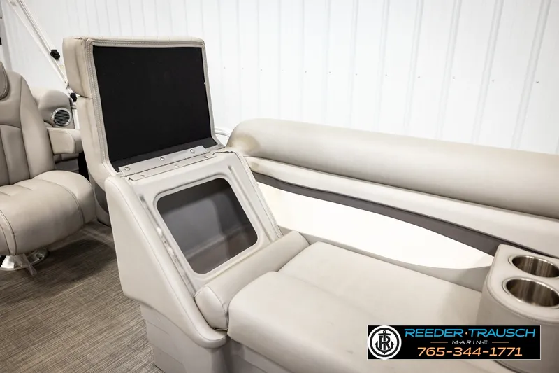 Slide: The Image of 2021 Bennington SVSR boat interior with storage compartment and cup holders. - 25