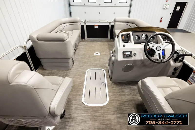 Slide: The Image of Interior of a 2021 Bennington SVSR pontoon boat with plush seating and modern controls. - 17