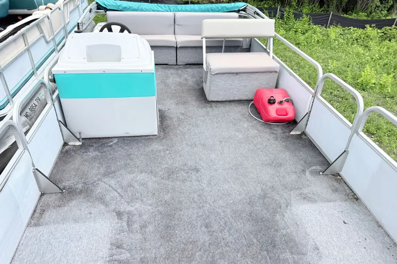 Slide: The Image of 1993 Crest Sport pontoon boat interior with seating and steering console. - 3