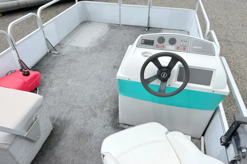 Slide: The Image of 1993 Crest Sport boat interior with steering wheel and seating area. - 6