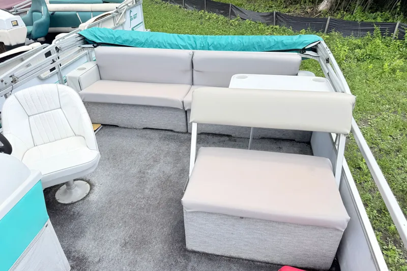 Slide: The Image of 1993 Crest Sport boat interior with gray seating and white captain's chair. - 4