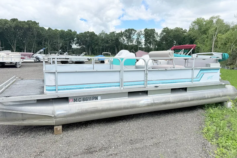The Image of 1993 Crest Sport pontoon boat parked on gravel lot with trees in background. - 0