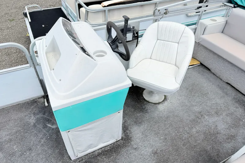 Slide: The Image of 1993 Crest Sport boat interior with white captain's chair and teal dashboard. - 5