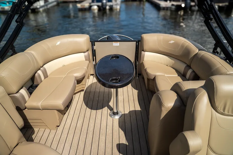 Slide: The Image of The image shows the interior of a 2021 Starcraft CX 21 R with beige leather seating and a round table. - 11