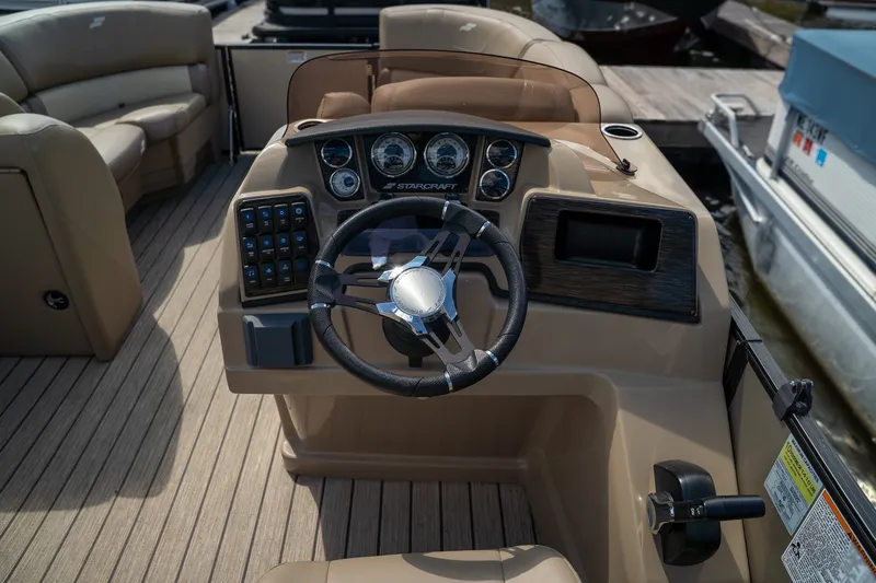 Slide: The Image of The image shows the cockpit of a 2021 Starcraft CX 21 R with a modern helm. - 10
