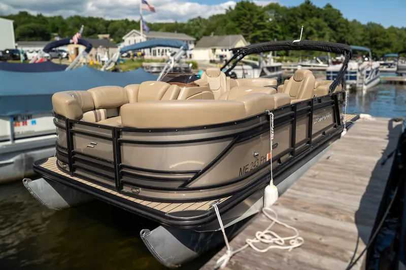 The Image of 2021 Starcraft CX 21 R pontoon boat at dock with beige seating and black railing. - 1