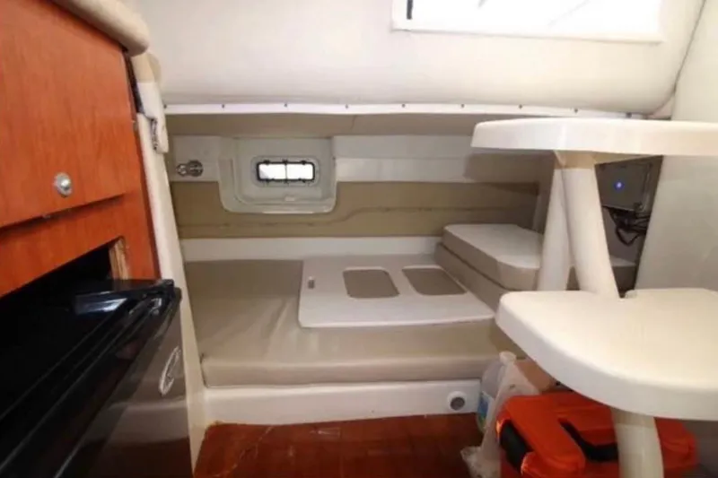 Slide: The Image of 2006 Pro-Line 32 Express cabin interior with seating, table, and storage. - 6
