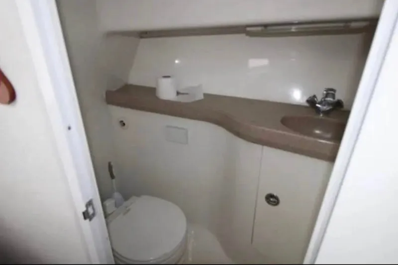 Slide: The Image of Compact bathroom in 2006 Pro-Line 32 Express boat with toilet and sink. - 5