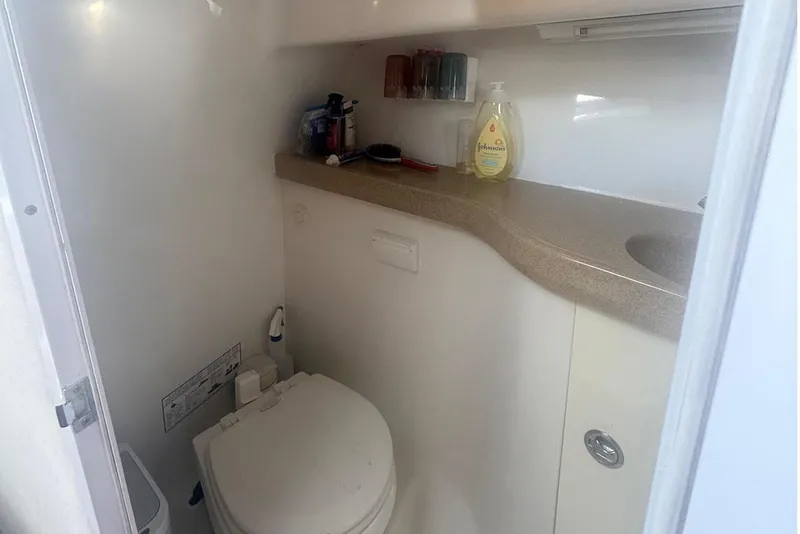 Slide: The Image of 2007 Pro-Line 32 Express boat bathroom with toilet, sink, and toiletries. - 4