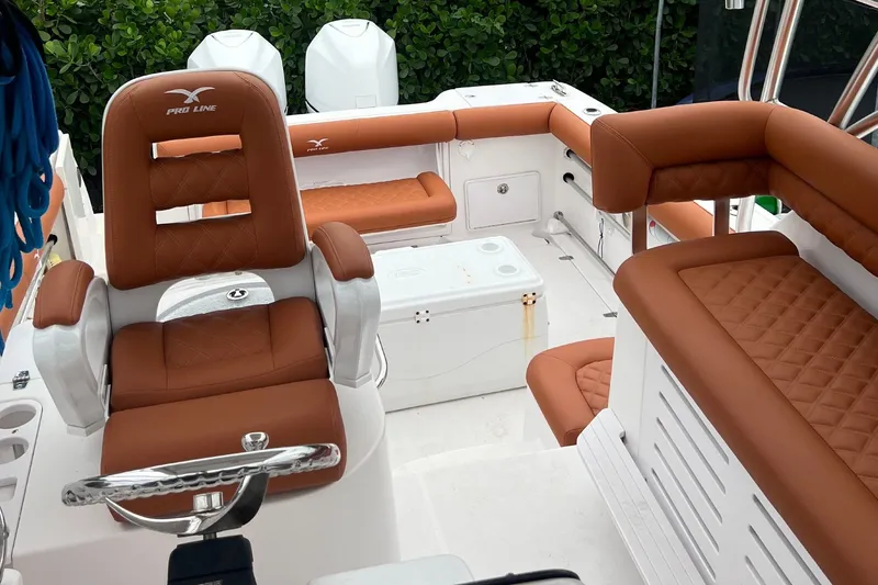 Slide: The Image of The image shows the cockpit of a 2006 Pro-Line 32 Express with brown leather seats and a helm. - 2