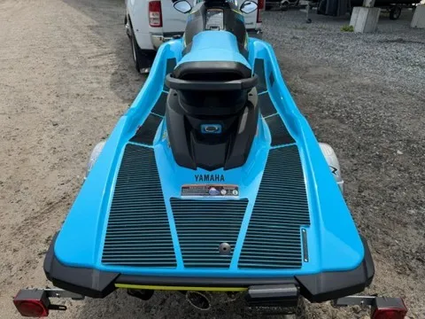 Slide: The Image of A blue 2023 Yamaha EX WaveRunner is on a trailer in a gravel lot. - 2