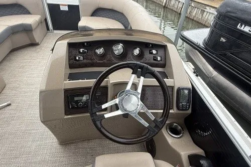 Slide: The Image of 2024 Bennington 22LSR boat dashboard with steering wheel and control panel. - 11