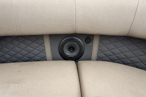 Slide: The Image of 2024 Bennington 22LSR boat interior with quilted upholstery and speaker detail. - 8
