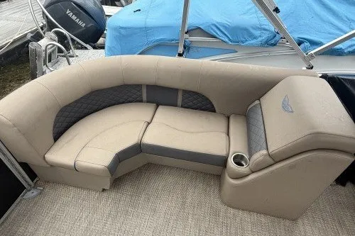 Slide: The Image of 2024 Bennington 22LSR boat interior with beige seating and cup holder. - 2