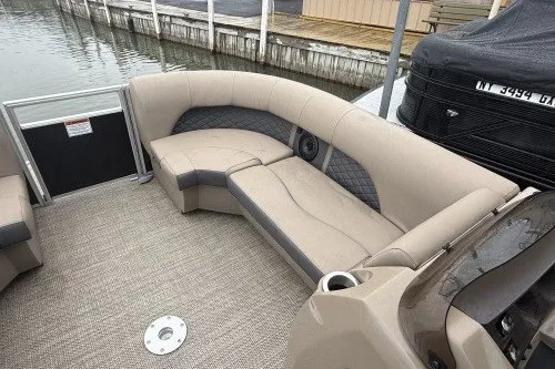 Slide: The Image of 2024 Bennington 22LSR pontoon boat with beige seating and modern design. - 6