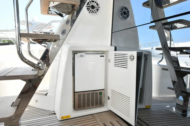 Slide: The Image of Prestige 590 yacht 2020 model, featuring an open storage compartment and sleek staircase design. - 41