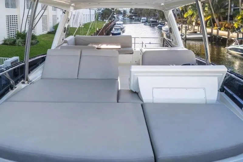 Slide: The Image of Prestige 590 yacht interior, 2020 model, featuring spacious seating and luxurious design. - 12