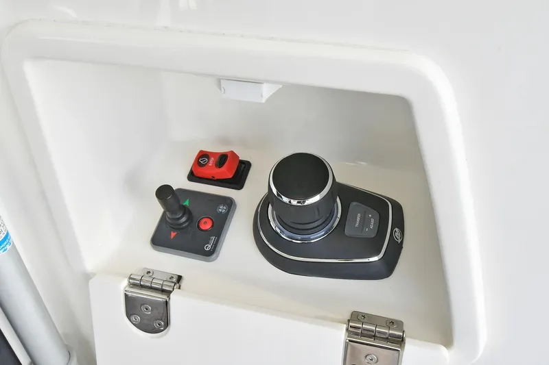 Slide: The Image of Control panel of a 2020 Prestige 590 yacht featuring joystick and throttle controls. - 43