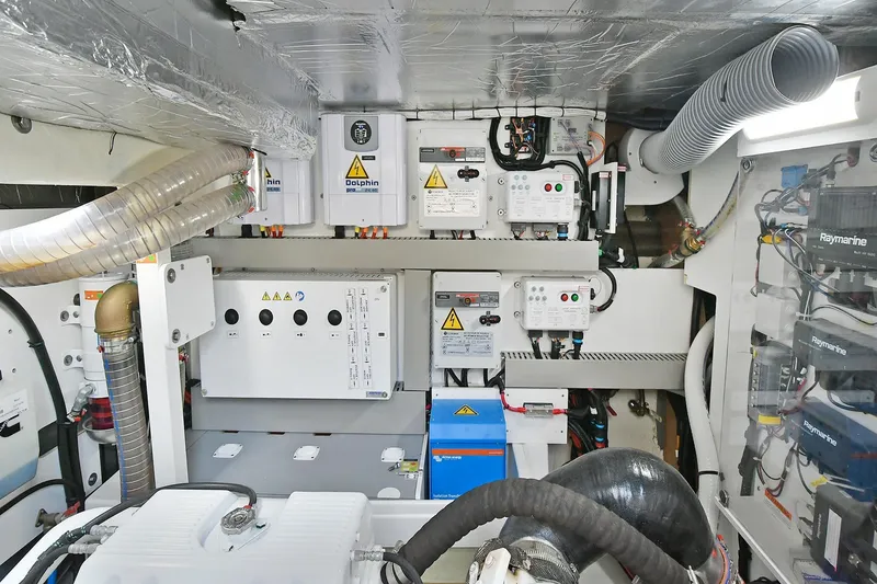 Slide: The Image of Engine room of a 2020 Prestige 590 yacht, showcasing electrical systems and components. - 46