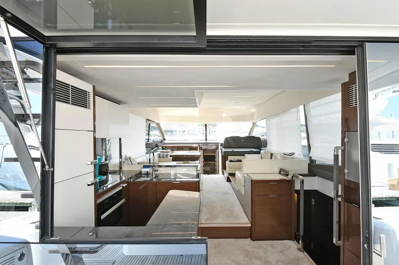 Slide: The Image of Luxurious interior of a 2020 Prestige 590 yacht, featuring modern kitchen and seating area. - 30