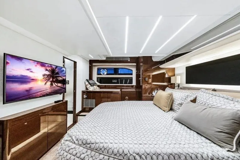 Slide: The Image of Luxurious interior of 2020 Prestige 590 yacht with elegant bedding and large TV. - 16