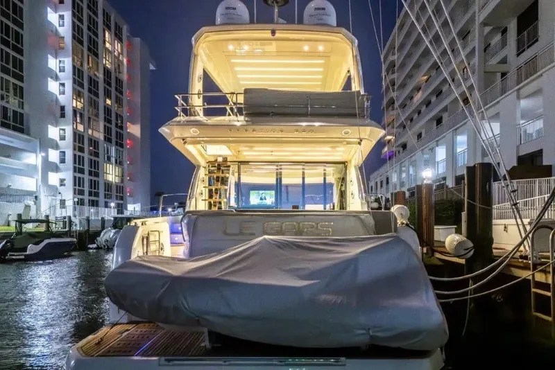 Slide: The Image of Luxurious 2020 Prestige 590 yacht docked at night, illuminated with elegant lighting. - 40