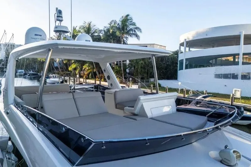 Slide: The Image of Luxury 2020 Prestige 590 yacht docked, featuring spacious outdoor seating and modern design. - 11