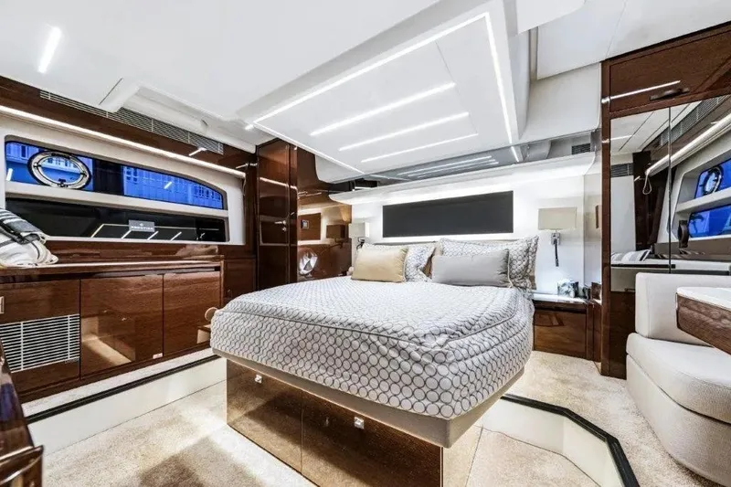 Slide: The Image of Luxurious interior of a 2020 Prestige 590 yacht with elegant bedding and modern lighting. - 21