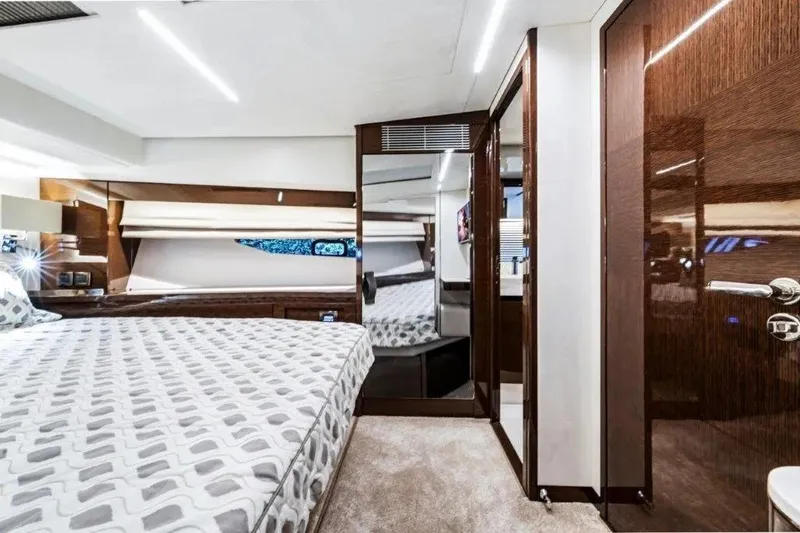 Slide: The Image of Luxurious 2020 Prestige 590 yacht bedroom with modern decor and elegant wood finishes. - 17