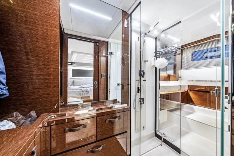 Slide: The Image of Luxurious bathroom interior on a 2020 Prestige 590 yacht, featuring modern design and elegant wood finishes. - 26