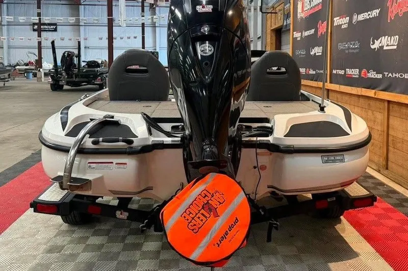 Slide: The Image of 2017 Nitro Z18 boat with motor, displayed indoors on a checkered floor. - 4