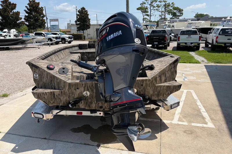 Slide: The Image of 2026 Excel 183 Tomahawk boat with Yamaha outboard motor, parked on a trailer. - 3