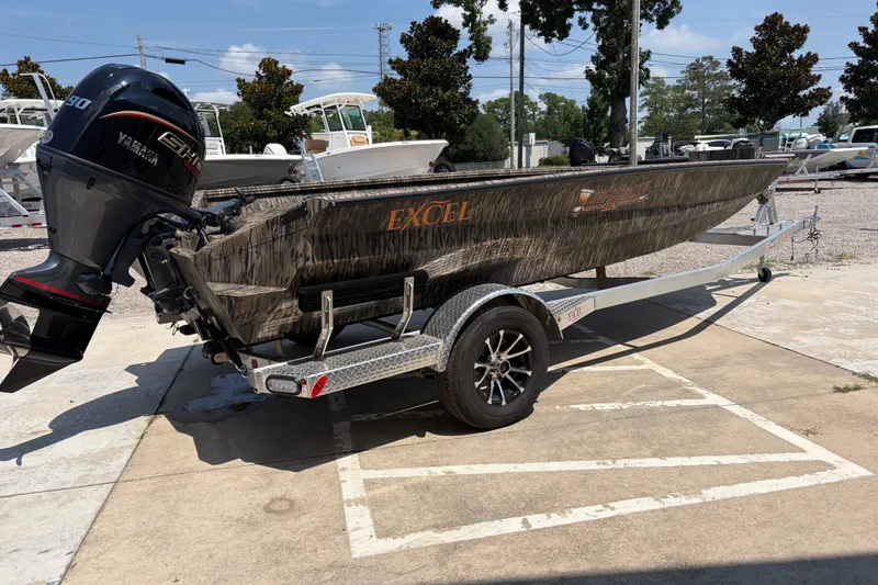 Slide: The Image of 2026 Excel 183 Tomahawk boat on trailer with Yamaha motor in parking lot. - 5