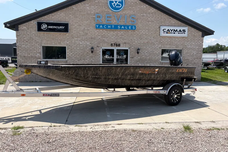 The Image of 2026 Excel 183 Tomahawk boat on trailer at Revis Yacht Sales dealership. - 1