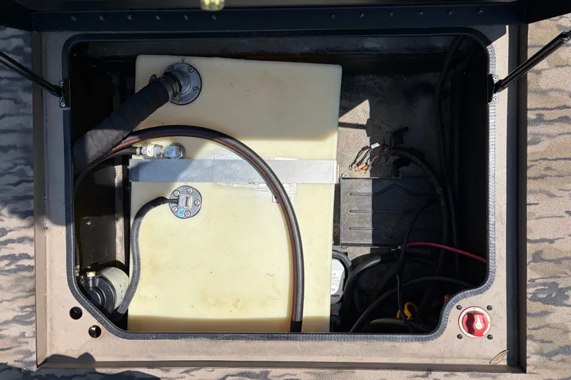 Slide: The Image of Fuel tank compartment of 2026 Excel 183 Tomahawk boat, showing hoses and wiring. - 13