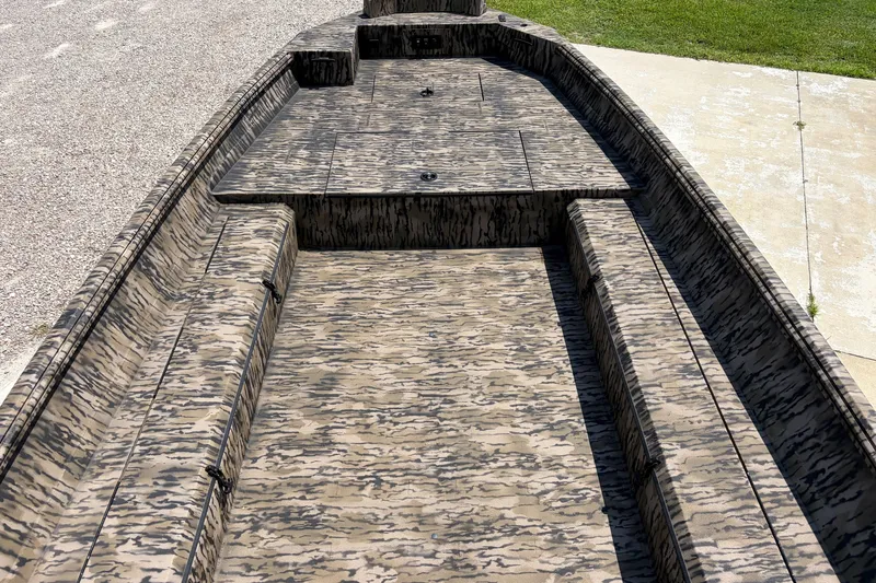 Slide: The Image of 2026 Excel 183 Tomahawk boat interior with camouflage pattern, parked on concrete and gravel. - 10