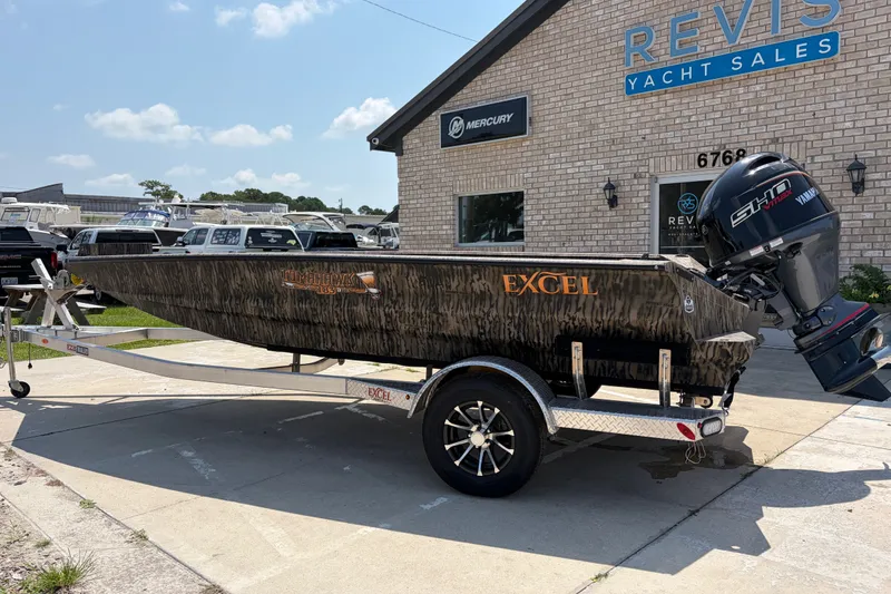 Slide: The Image of 2026 Excel 183 Tomahawk boat on trailer at Revis Yacht Sales dealership. - 2