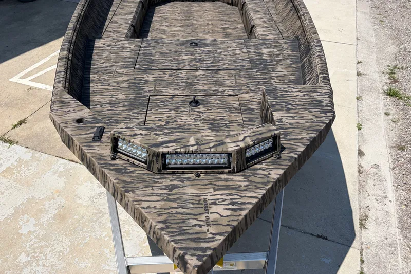 Slide: The Image of Camouflage-patterned 2026 Excel 183 Tomahawk boat with LED lights on a concrete surface. - 7