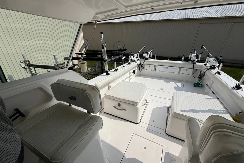 Slide: The Image of Interior view of a 2006 Baha Cruiser 299 SF boat with seating and fishing rod holders. - 15