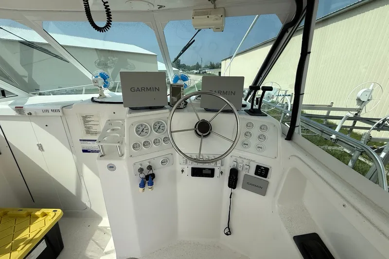 Slide: The Image of 2006 Baha Cruiser 299 SF helm with Garmin navigation, steering wheel, and control panel. - 11