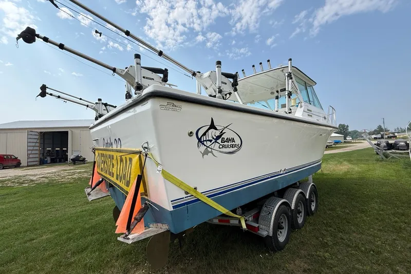 Slide: The Image of 2006 Baha Cruiser 299 SF boat on trailer, marked with "Oversize Load" sign. - 3